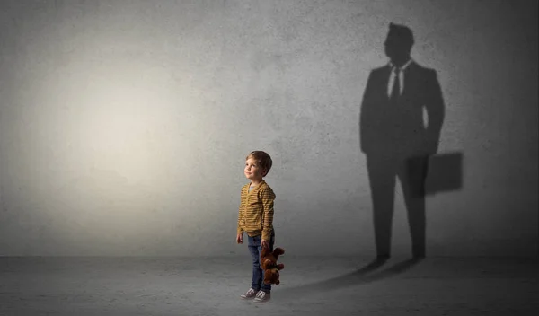 Little boy with businessman shadow Stock Photo