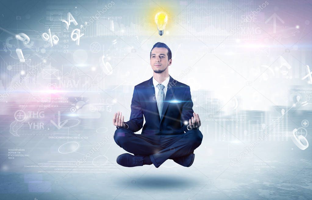 Businessman meditates with enlightenment concept