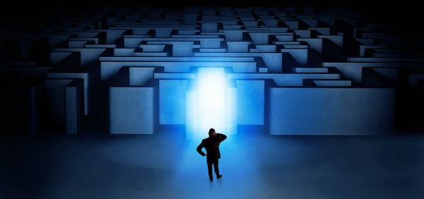 Lost businessman standing at illuminated labyrinth entrance — Stock Photo, Image