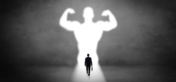 Businessman standing in front of a strong hero vision — Stock Photo, Image