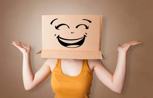 Young woman  with cardboard box on her head — Stock Photo, Image