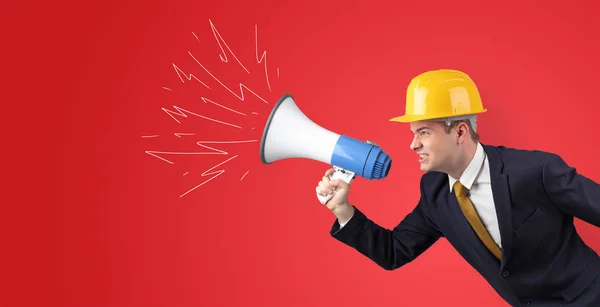 Young architect yelling with megaphone — Stock Photo, Image