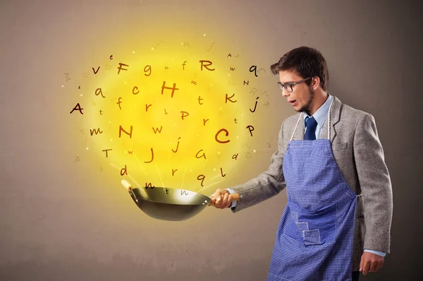 Person cooking letters in wok — Stock Photo, Image