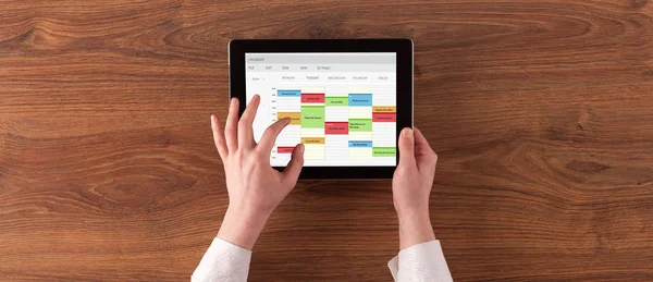 Hand holding tablet with timetable concept — Stock Photo, Image