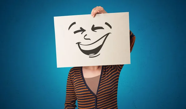 Person holding a paper with cool emoticon face — Stock Photo, Image