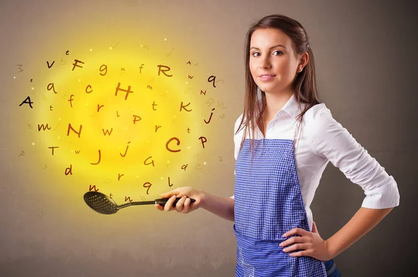 Person cooking letters in wok — Stock Photo, Image