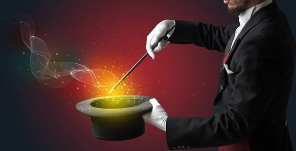 Illusionist hand making trick with wand — Stock Photo, Image