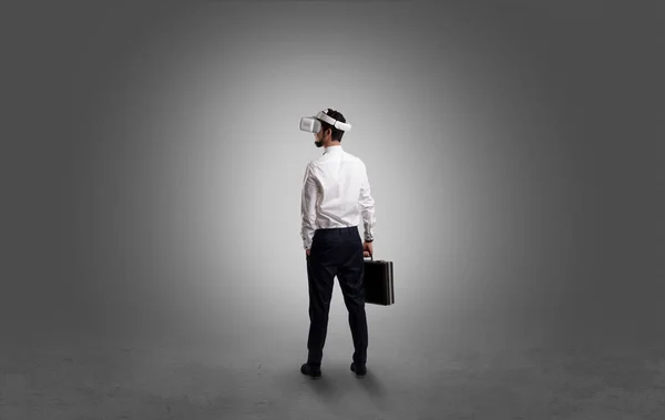 Businessman in an empty room with vr glasses — Stock Photo, Image