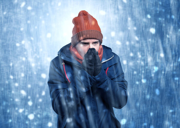 Handsome boy shivering at snowstorm concept