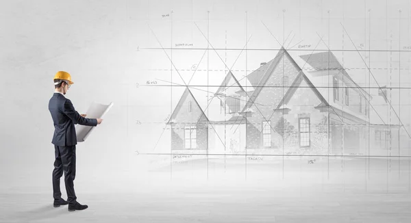 Architect standing with house plan — Stock Photo, Image
