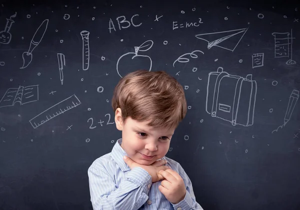 Little boy in front of a drawn up blackboard — Stock Photo, Image