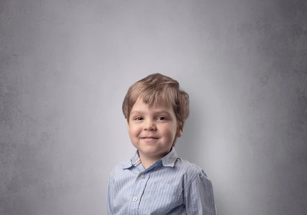 Entzückender kleiner Junge vor einer leeren Wand — Stockfoto
