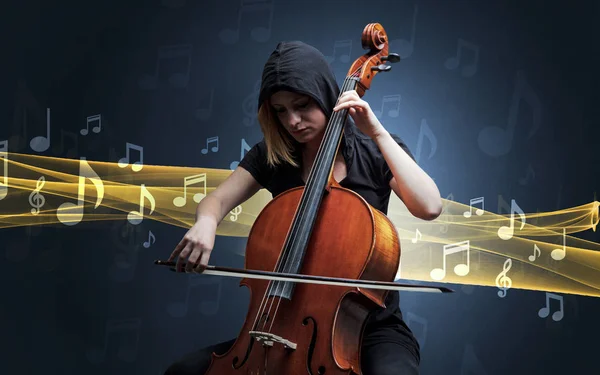 Músico tocando el violonchelo con notas alrededor —  Fotos de Stock