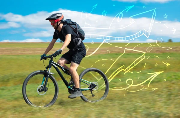 Young cyclist in with meadow background — Stock Photo, Image