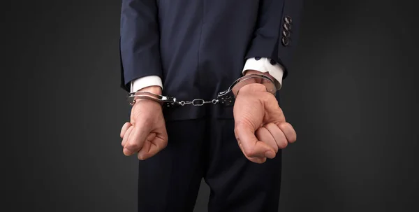 Dark backgrounded close handcuffed man — Stock Photo, Image