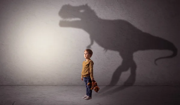 Dinosaurus shadow behind cute boy — Stock Photo, Image