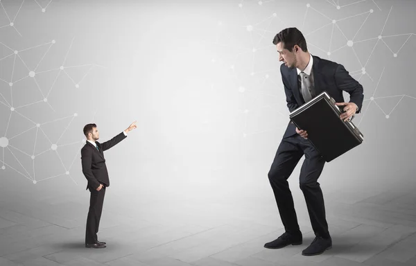 Small man aiming at a big man with network concept — Stock Photo, Image