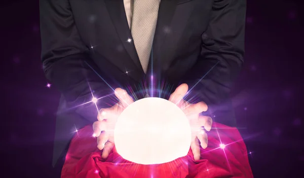 Businessman sitting with crystal ball in action — Stock Photo, Image