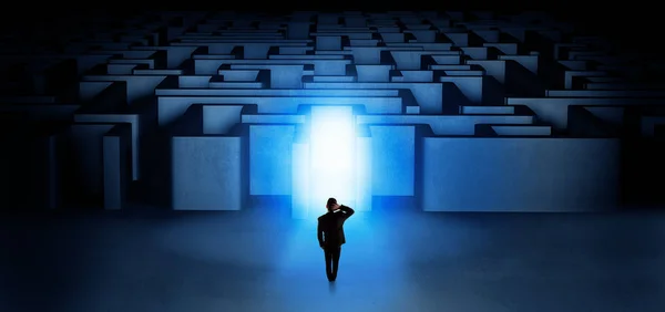 Lost businessman standing at illuminated labyrinth entrance — Stock Photo, Image