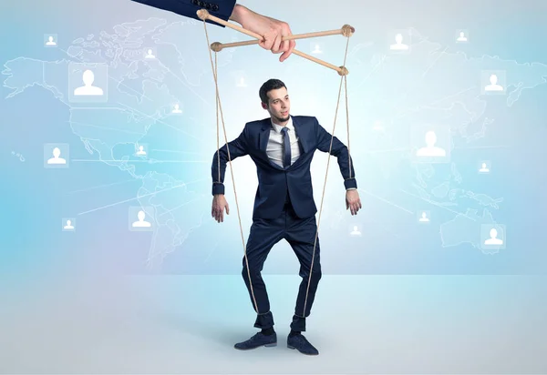 Little businessman controlled from above by another big hand — Stock Photo, Image