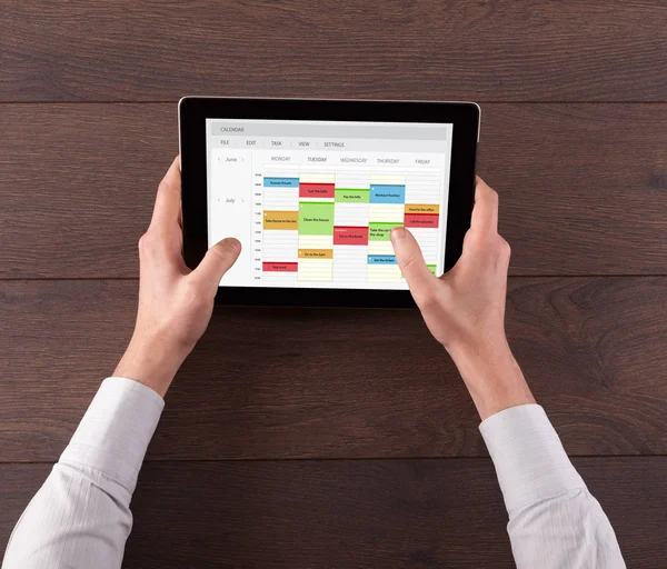 Hand holding tablet with timetable concept — Stock Photo, Image