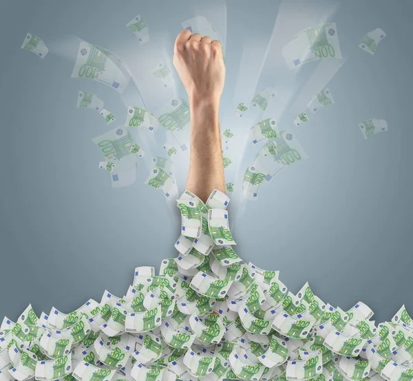 Hand buried in cash pile and trying to get out — Stock Photo, Image