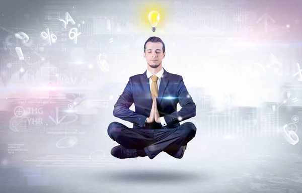 Businessman meditates with enlightenment concept — Stock Photo, Image