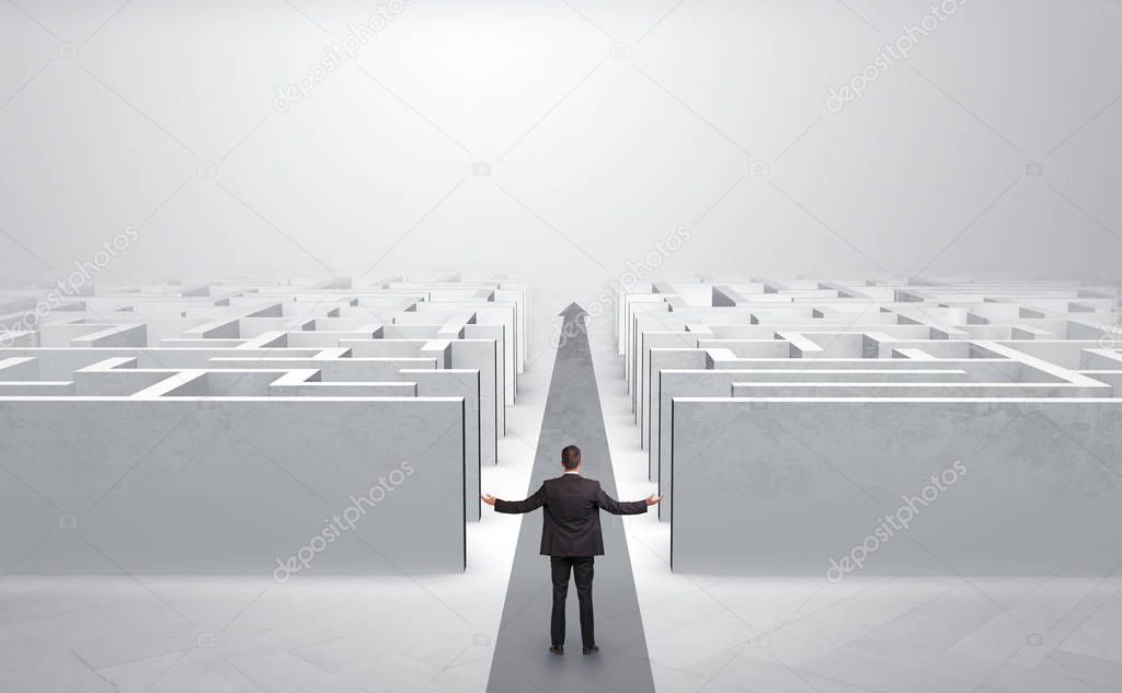 Businessman going straight ahead between two mazes
