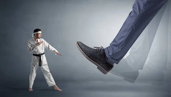 Big foot treading small karate man — Stock Photo, Image