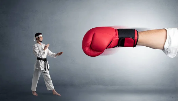 Pequeno homem lutando com grande luva de boxe vermelho — Fotografia de Stock