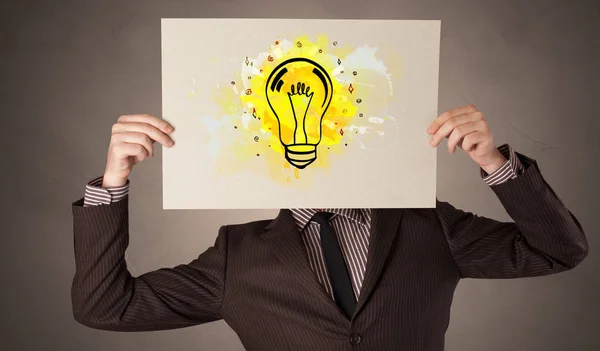 Person holding a paper with colorful bulb concept — Stock Photo, Image