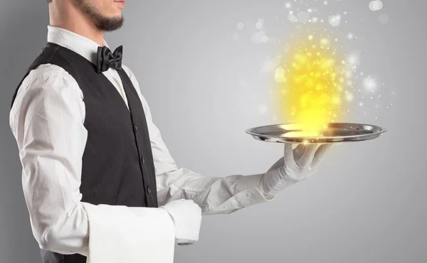 Waiter serving mysterious light on tray — Stock Photo, Image