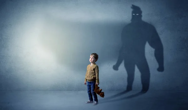 Cute kid with hero shadow behind — Stock Photo, Image