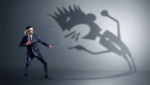 Karate man fighting with a big scary shadow — Stock Photo, Image