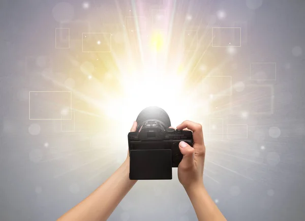 Hand taking photo with glowing flash concept — Stock Photo, Image