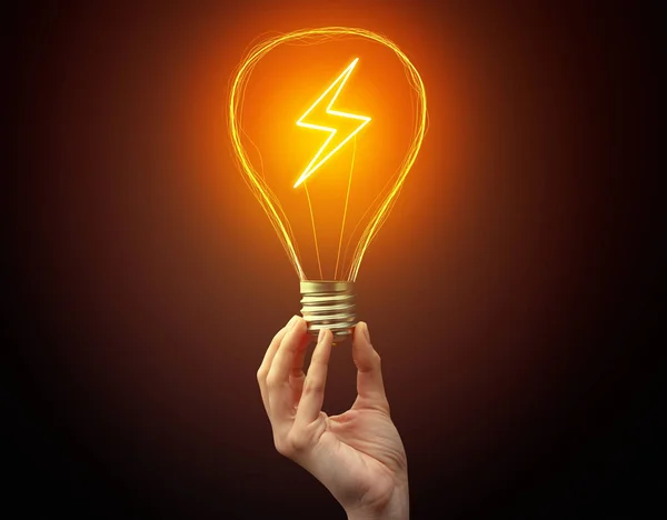 Hand holding light bulb on dark background — Stock Photo, Image