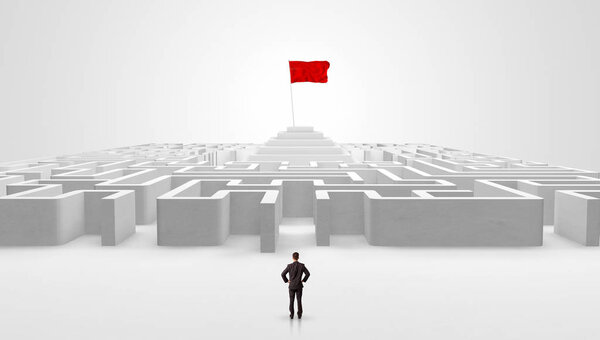 Man standing outside of a maze with pirate flag
