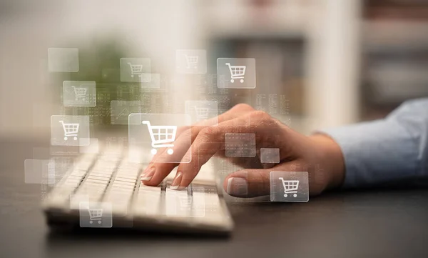 Hand typing on keyboard with store concept around — Stock Photo, Image