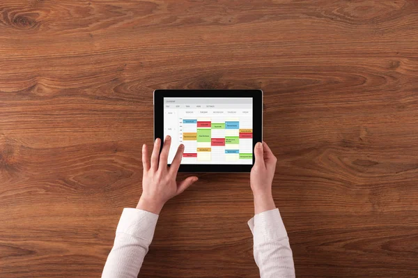 Hand holding tablet with timetable concept — Stock Photo, Image