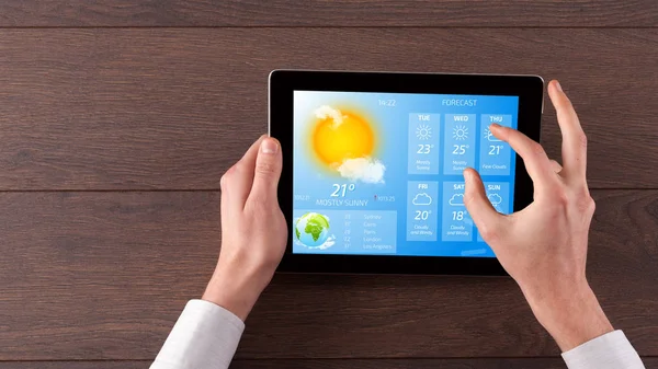 Hand checking weather on tablet — Stock Photo, Image