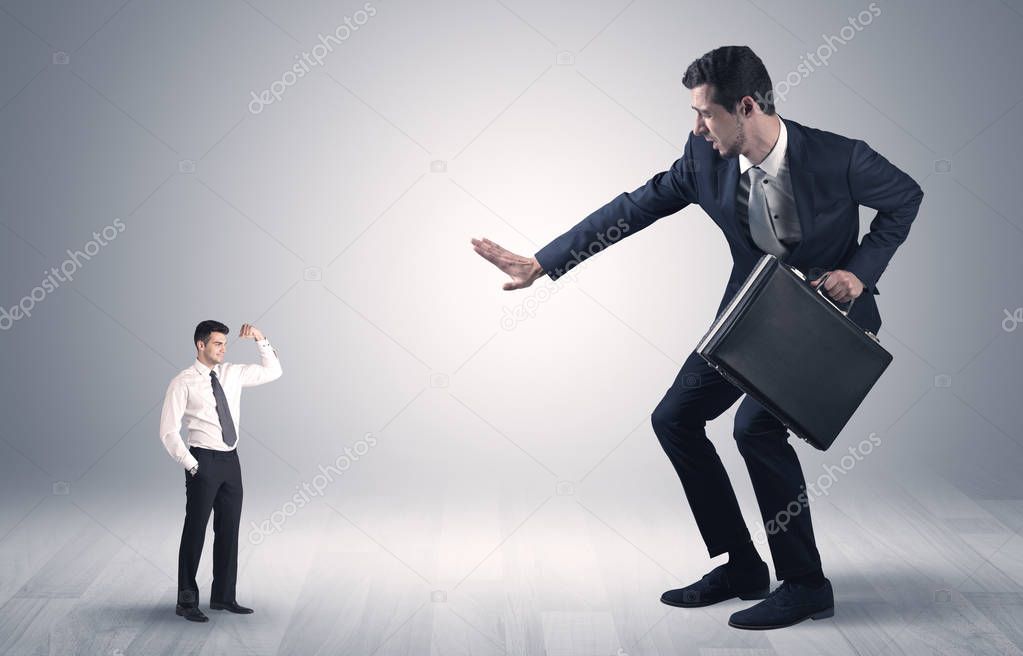 Giant businessman scared of small businessman