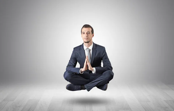 Businessman meditates in an empty space concept — Stock Photo, Image