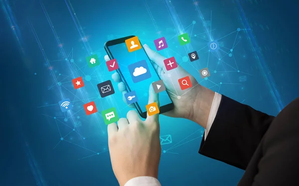 Hand using smartphone with application icons — Stock Photo, Image