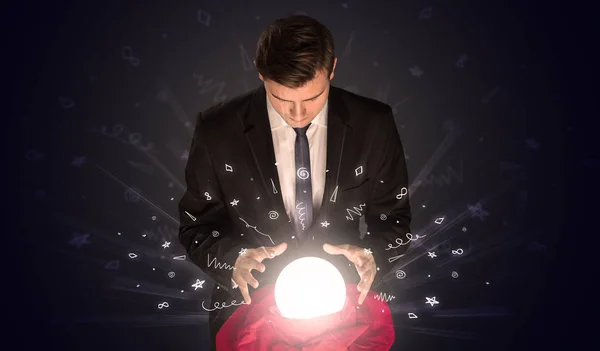 Businessman looking to inspiration in a magic ball and doodle concept — Stock Photo, Image