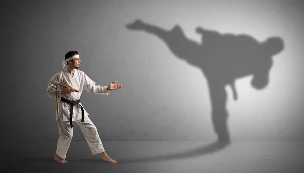 Karate man confronting with his own shadow — Stock Photo, Image
