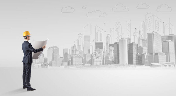 Architect standing and  replanning a city panorama