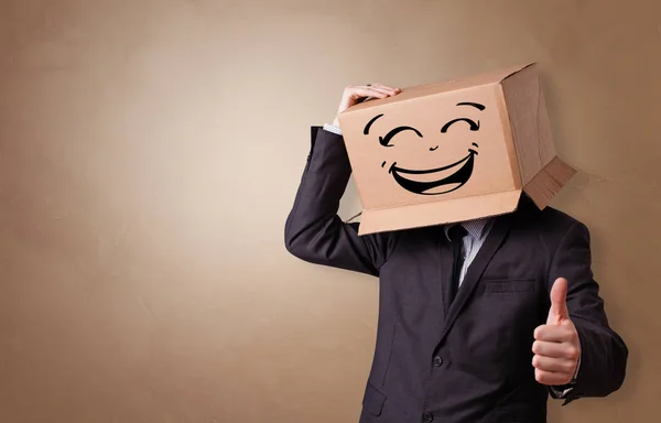 Young man  with cardboard box on his head — Stock Photo, Image