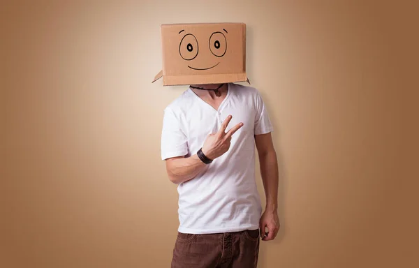 Man with smiling carton box head — Stock Photo, Image