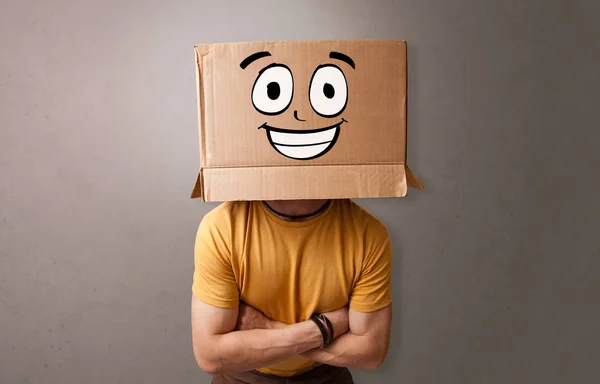 Young boy with happy cardboard box face — Stock Photo, Image