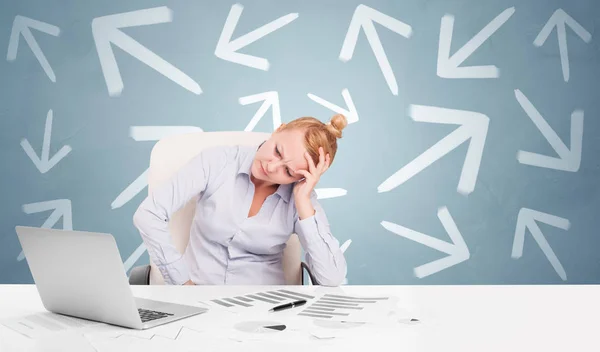 Business person sitting at desk with direction concept — Stock Photo, Image